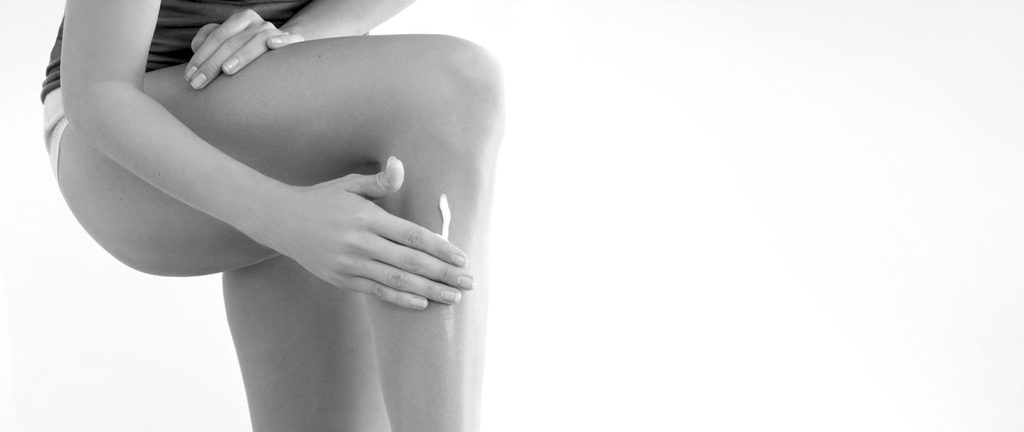Woman touching her left leg