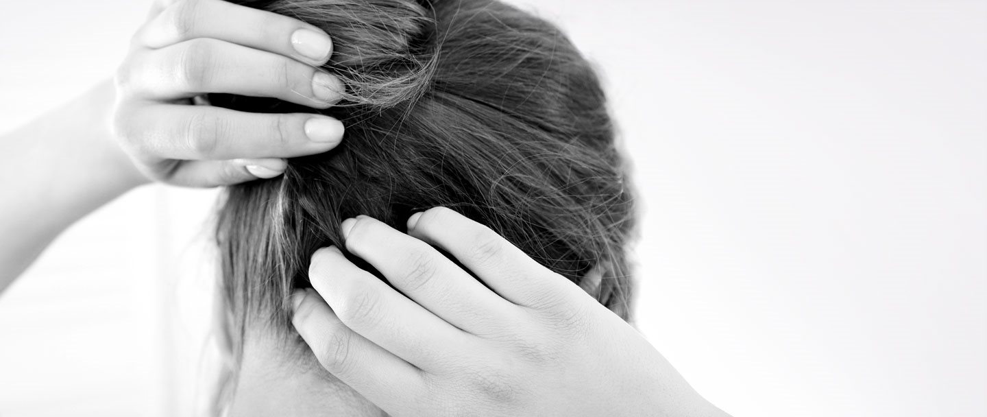 A woman scratching her itchy scalp